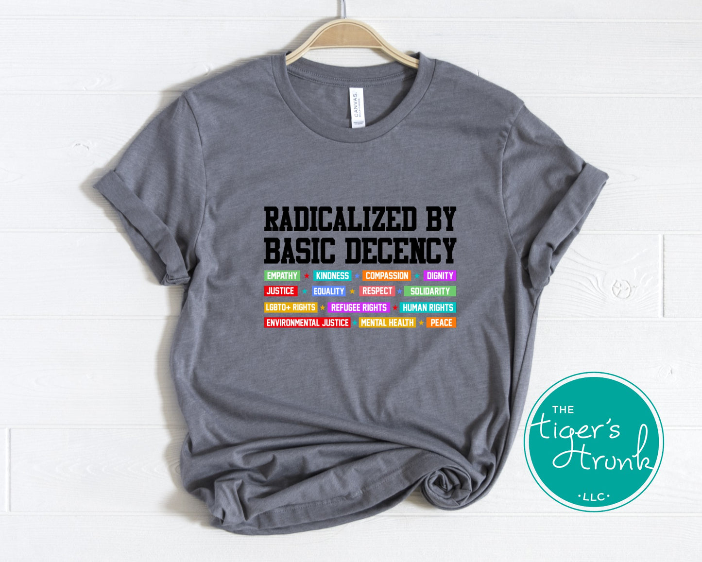Gray t-shirt with text and symbols on a white background, featuring the brand 'The Tiger's Trunk'.