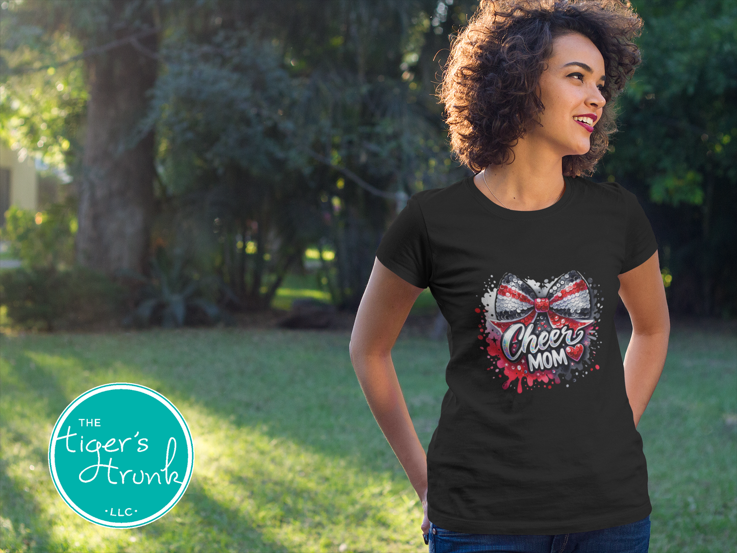 Woman wearing a black t-shirt with 'Cheer Mom' design outdoors