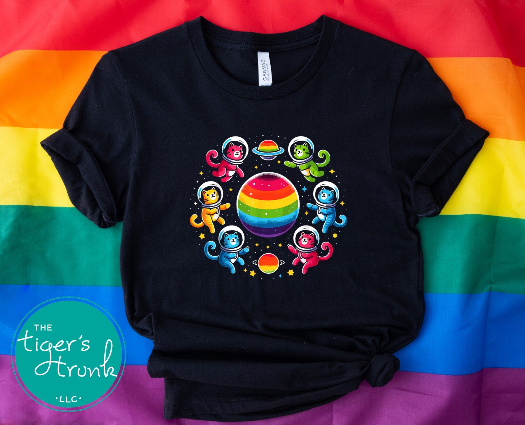 T-shirt with cats in space suits flying around a rainbow-colored planet, LGBTQ+ Pride graphic with a fun cosmic and cat theme
