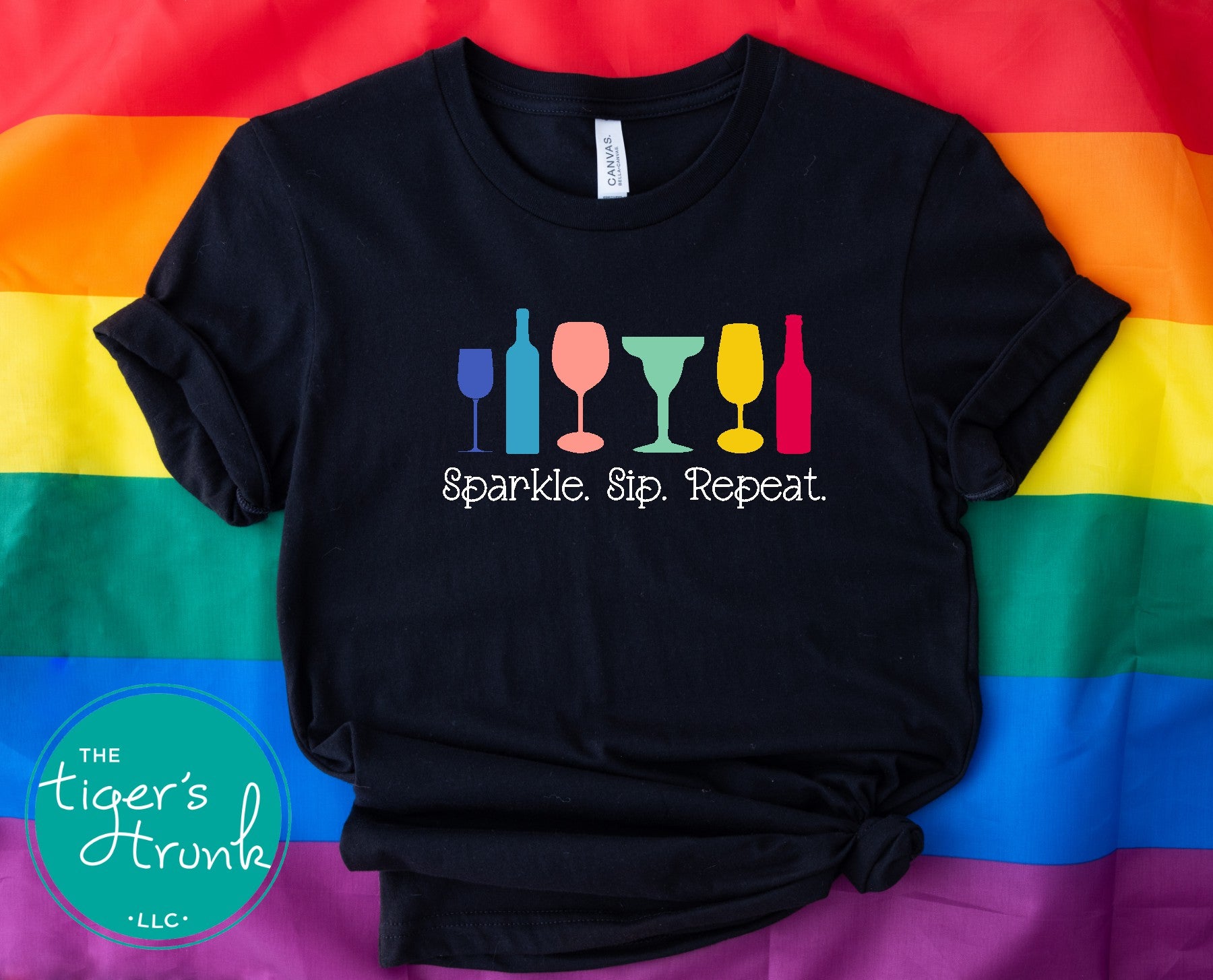 T-shirt with the phrase "Sparkle, Sip, Repeat" and rainbow-colored wine, beer, and cocktail glasses, Pride graphic for LGBTQ+ community and allies
