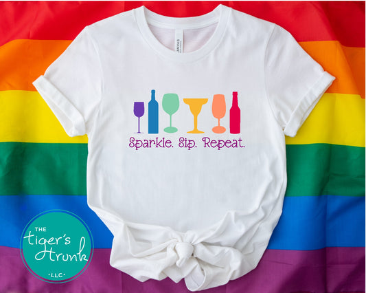 T-shirt with the phrase "Sparkle, Sip, Repeat" and rainbow-colored wine, beer, and cocktail glasses, Pride graphic for LGBTQ+ community and allies