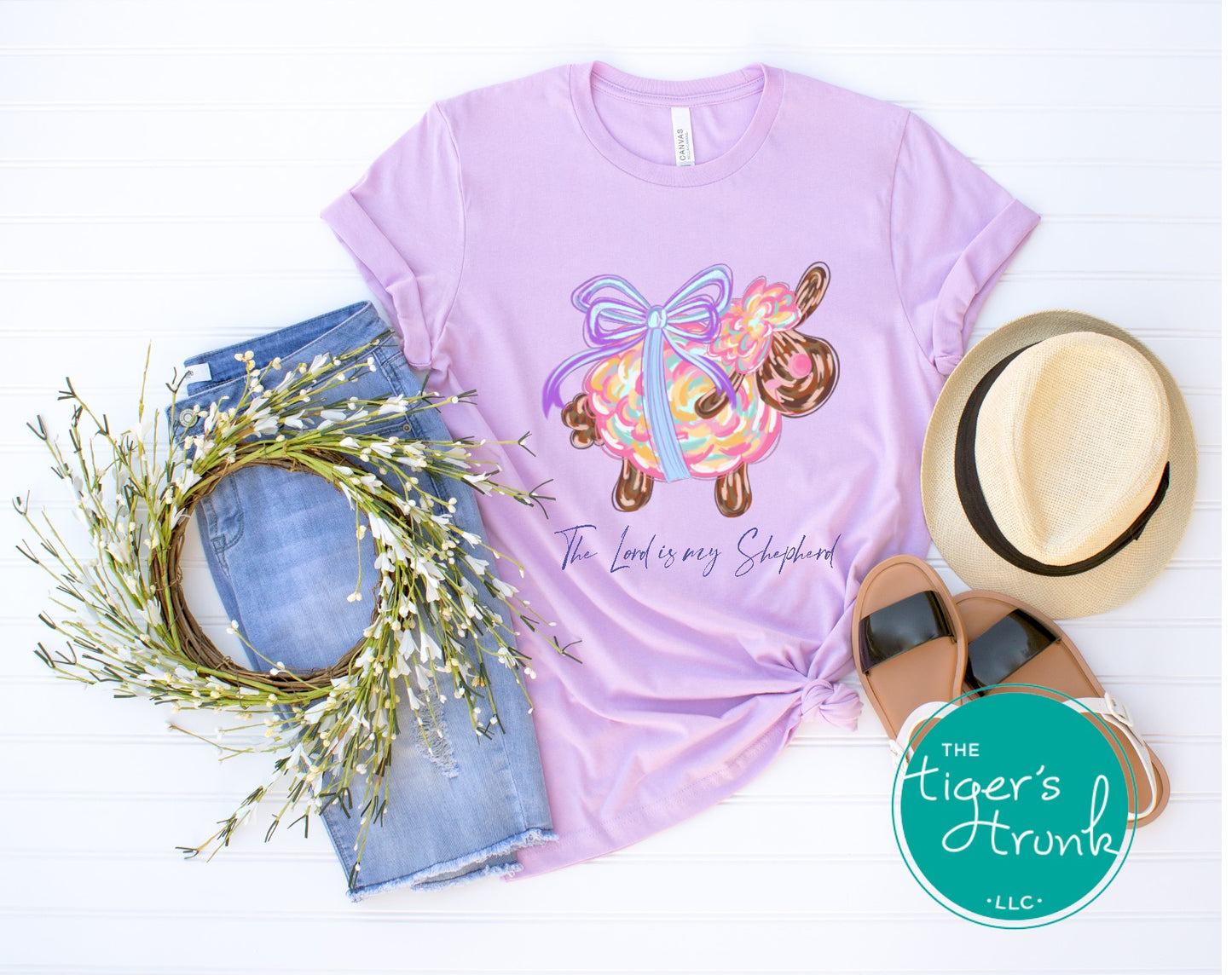 Christian Easter t-shirt with watercolor sheep and Psalm 23:1, featuring the verse "The Lord is my shepherd" in soft, faith-inspired design.