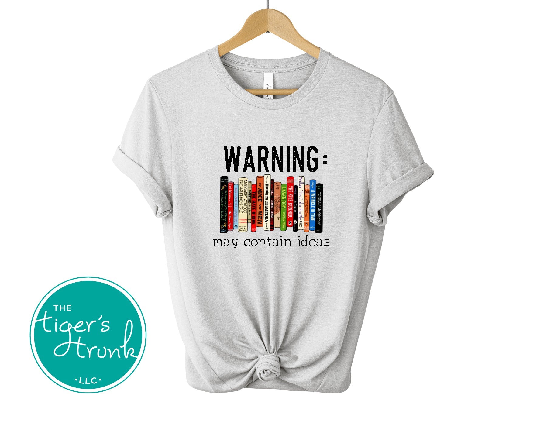 Graphic t-shirt featuring banned books and the phrase "Warning: May Contain Ideas," ideal for librarians, educators, and book lovers