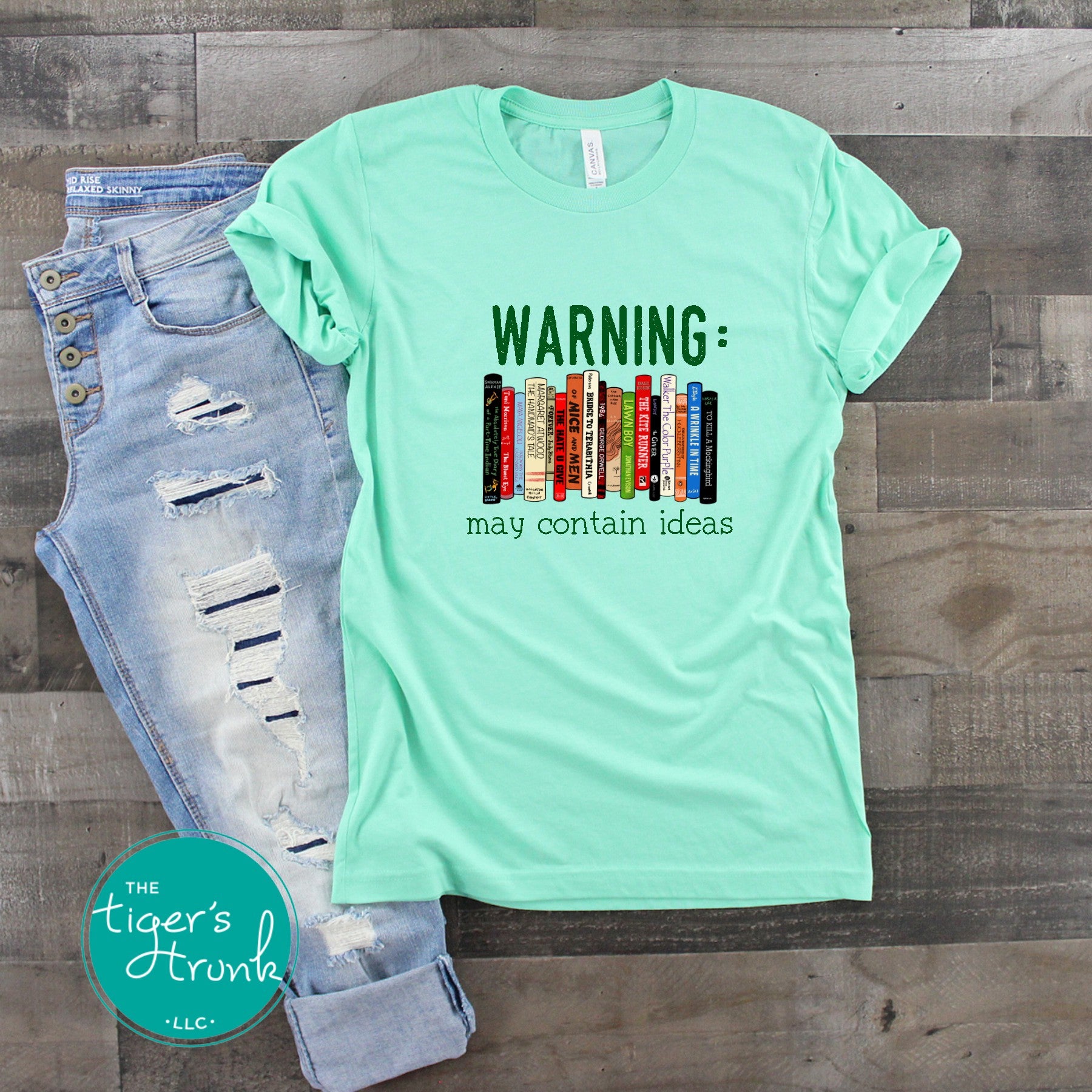 Graphic t-shirt featuring banned books and the phrase "Warning: May Contain Ideas," ideal for librarians, educators, and book lovers