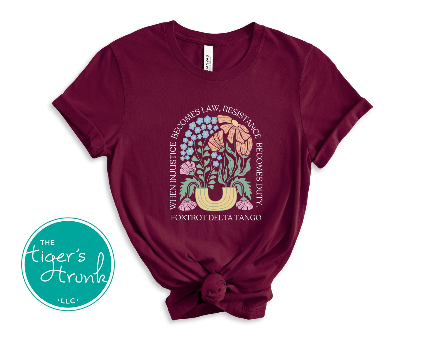 Maroon t-shirt with floral graphic and text on a white background, featuring 'The Tiger's Strunk' logo.
