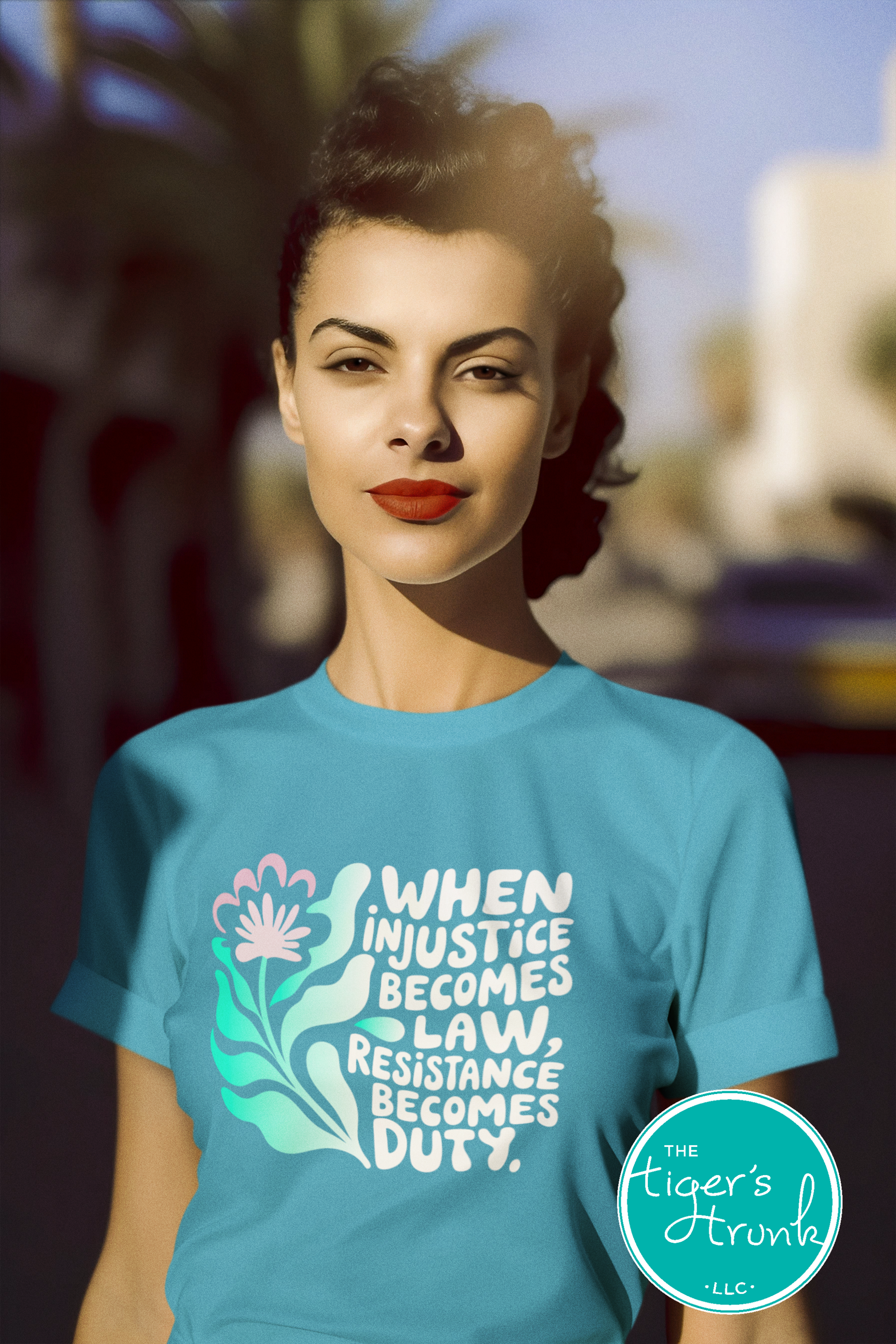 Woman wearing a blue t-shirt with a quote and 'The Tiger's Trunk' logo.