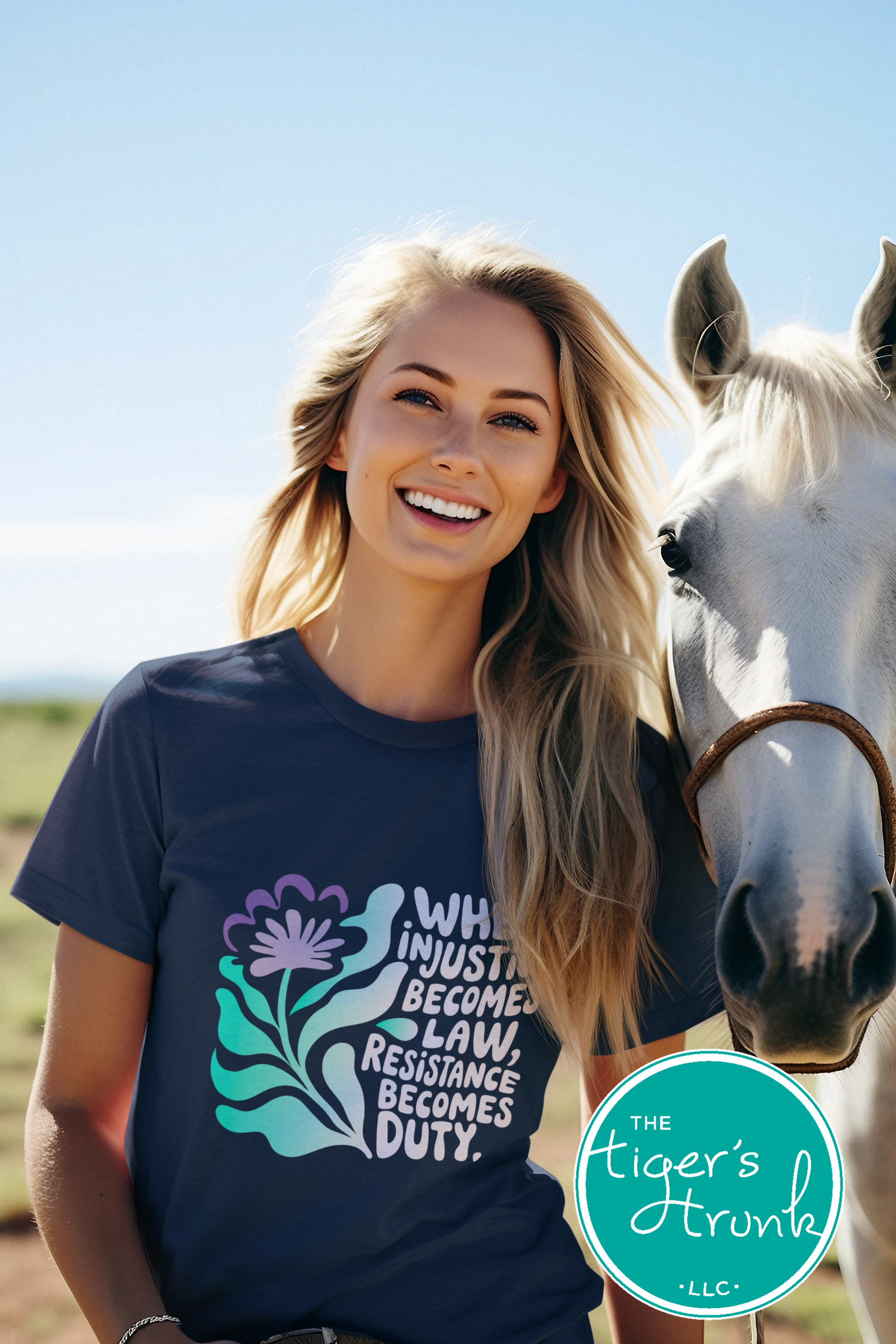 Woman wearing a t-shirt with a graphic design and text, standing next to a horse with 'The Tiger's Trunk' logo.