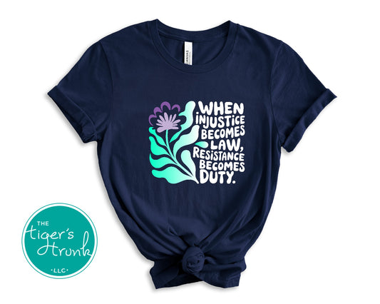 Navy blue t-shirt with motivational quote and floral design on a white background, featuring 'The Tiger's Den' logo.
