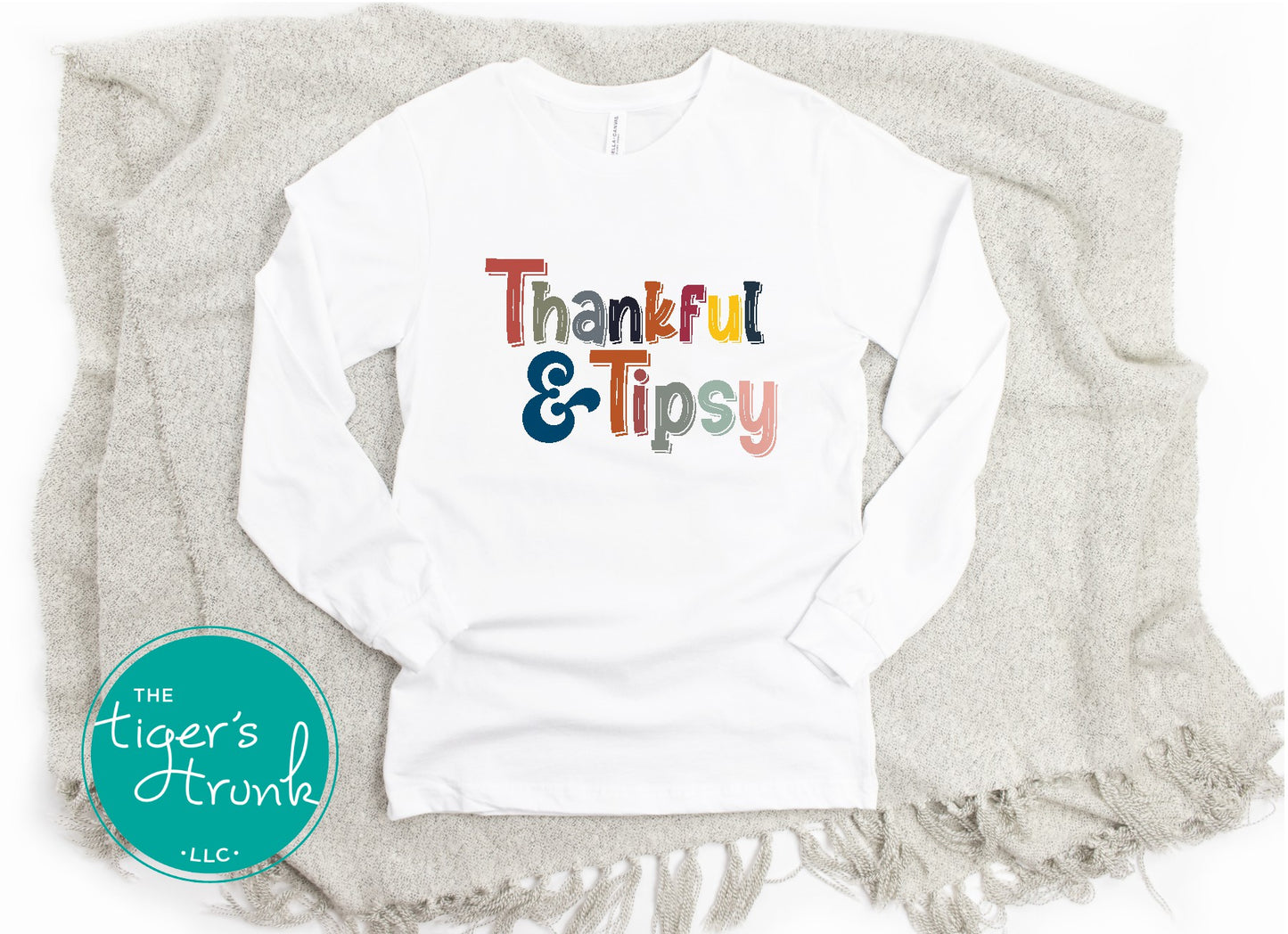 Funny Thanksgiving shirt with colorful “Thankful & Tipsy” text, available in long or short sleeves