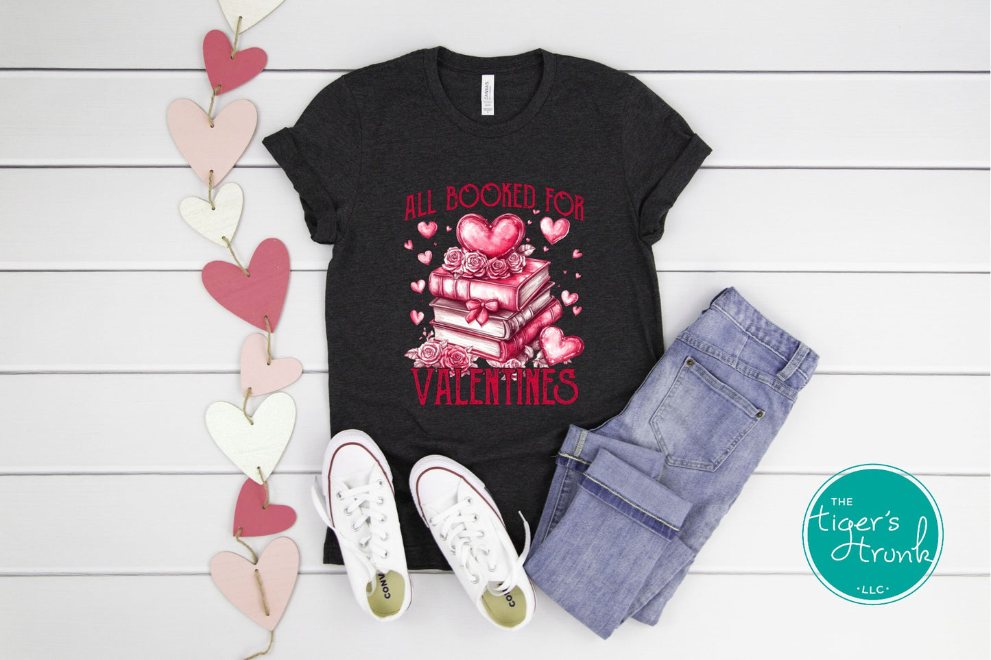 Shirt with stacked books, hearts, and roses, featuring the phrase "All Booked for Valentine’s." Perfect for book lovers.