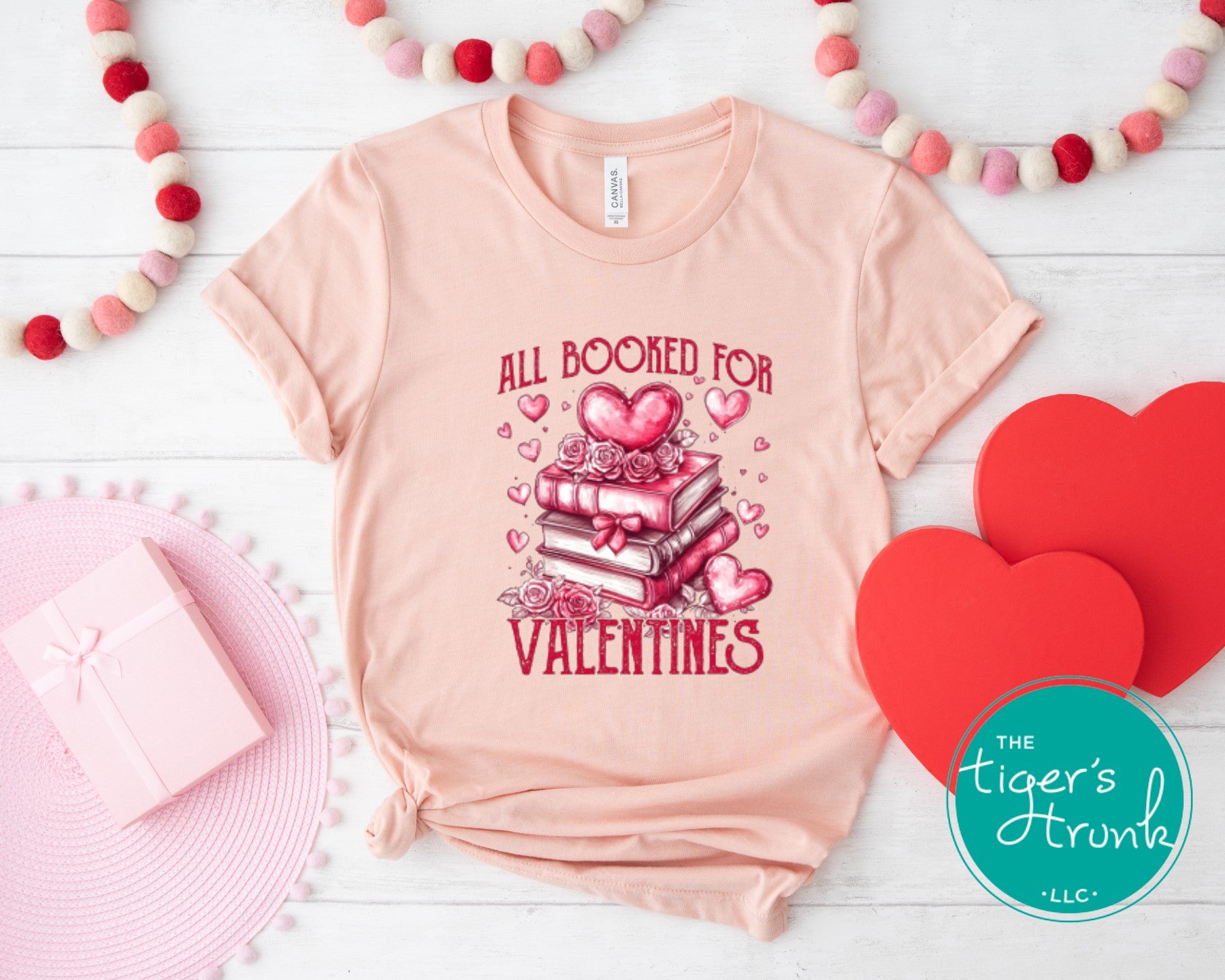 Shirt with stacked books, hearts, and roses, featuring the phrase "All Booked for Valentine’s." Perfect for book lovers.