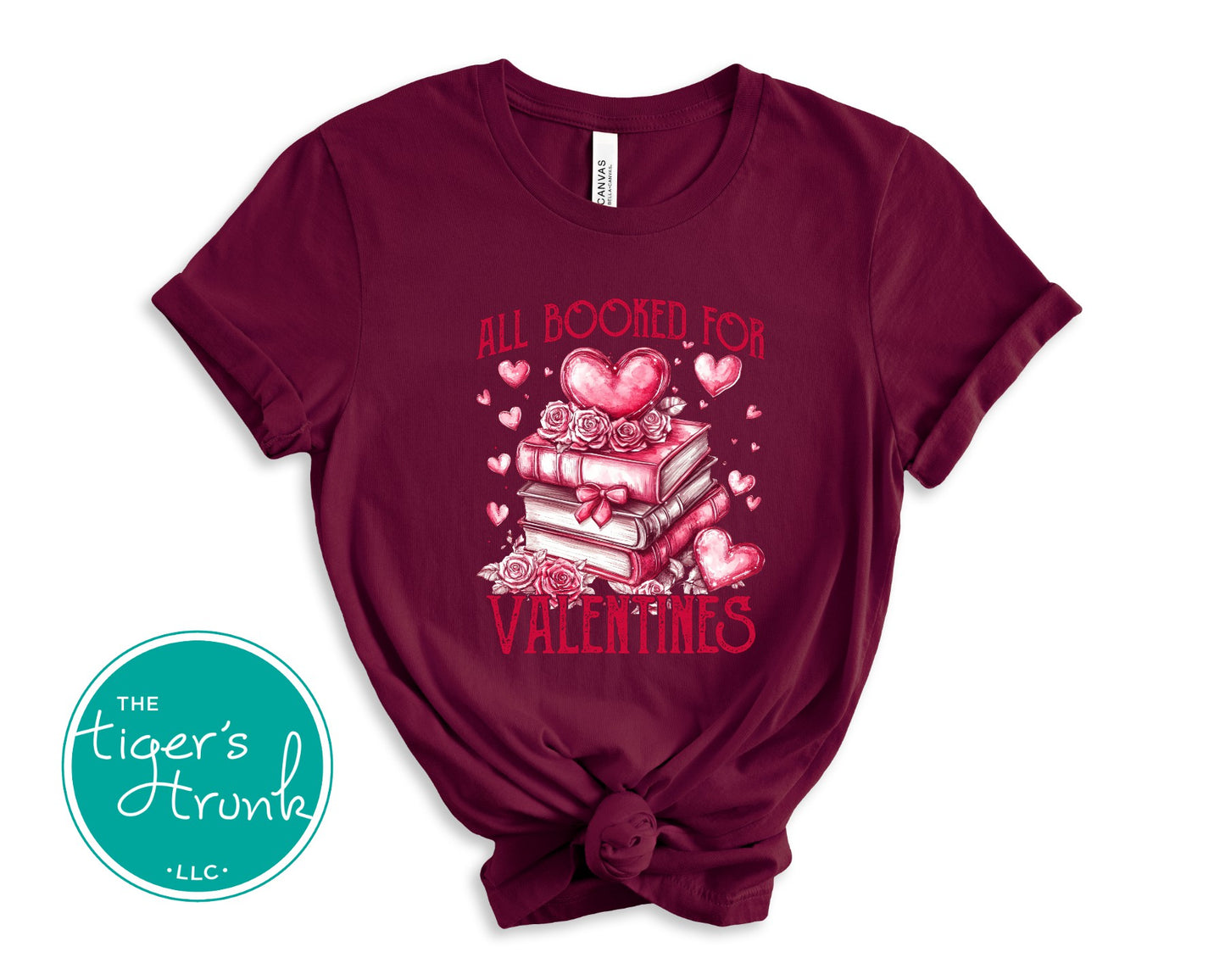 Shirt with stacked books, hearts, and roses, featuring the phrase "All Booked for Valentine’s." Perfect for book lovers.