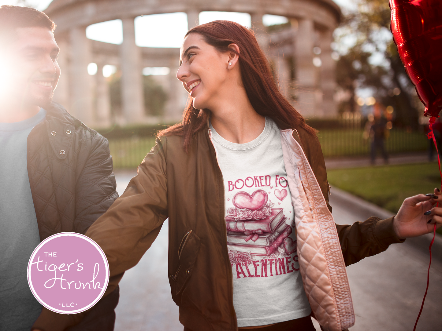 Shirt with stacked books, hearts, and roses, featuring the phrase "All Booked for Valentine’s." Perfect for book lovers.