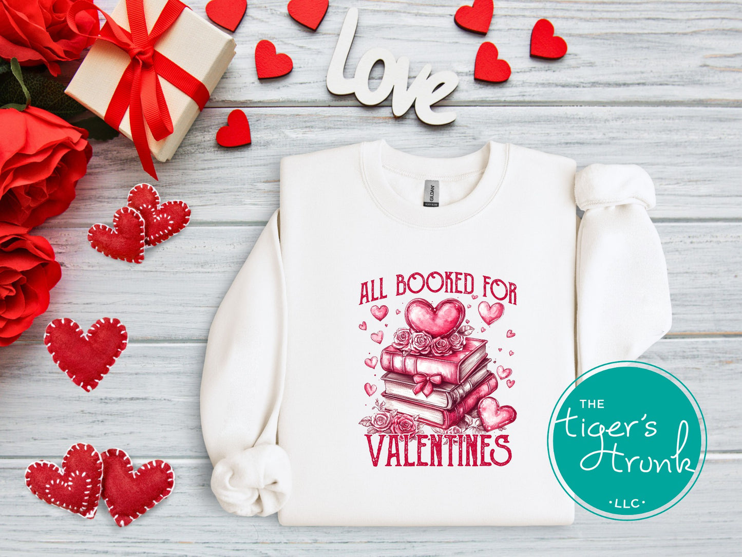 Shirt with stacked books, hearts, and roses, featuring the phrase "All Booked for Valentine’s." Perfect for book lovers.