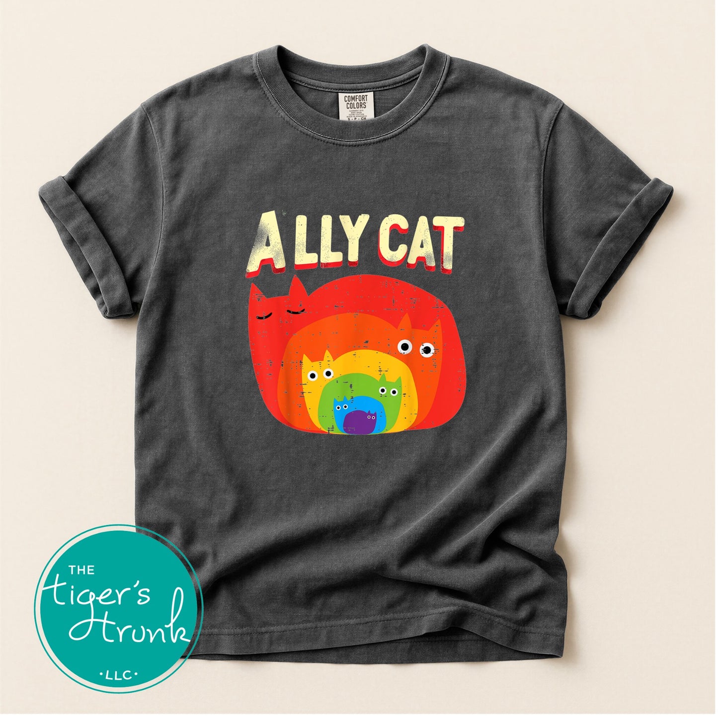 Gray t-shirt with colorful 'Ally Cat' graphic and 'The Tiger's Trunk' logo.
