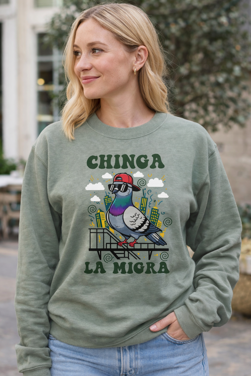 Woman wearing a green sweatshirt with a graphic design and text outdoors.