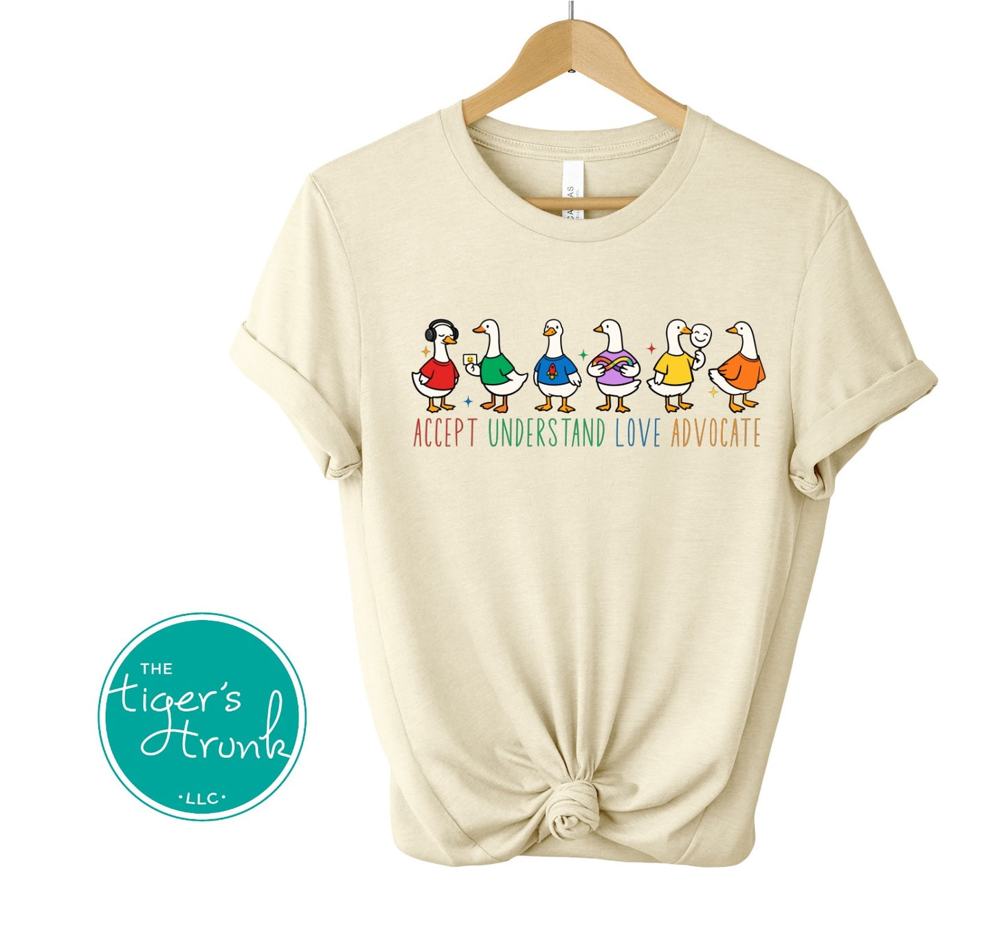 natural beige autism awareness shirt with colorful ducks and accept understand love advocate message
