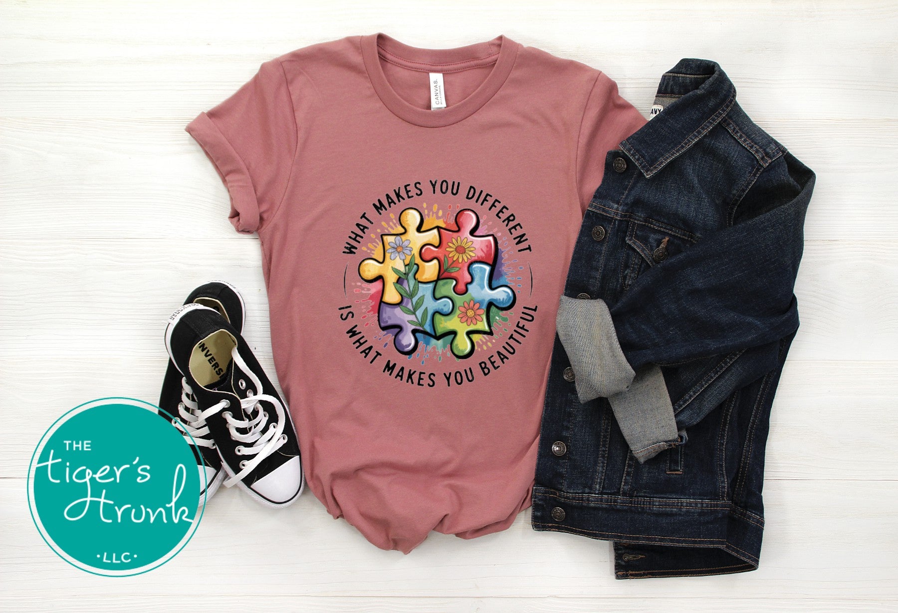 mauve autism acceptance shirt with colorful puzzle design and what makes you different is beautiful message