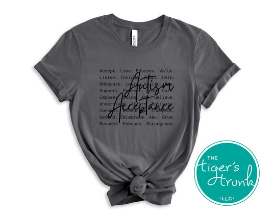 Gray t-shirt with 'Autism Acceptance' text and The Tiger's Trunk logo on a white background