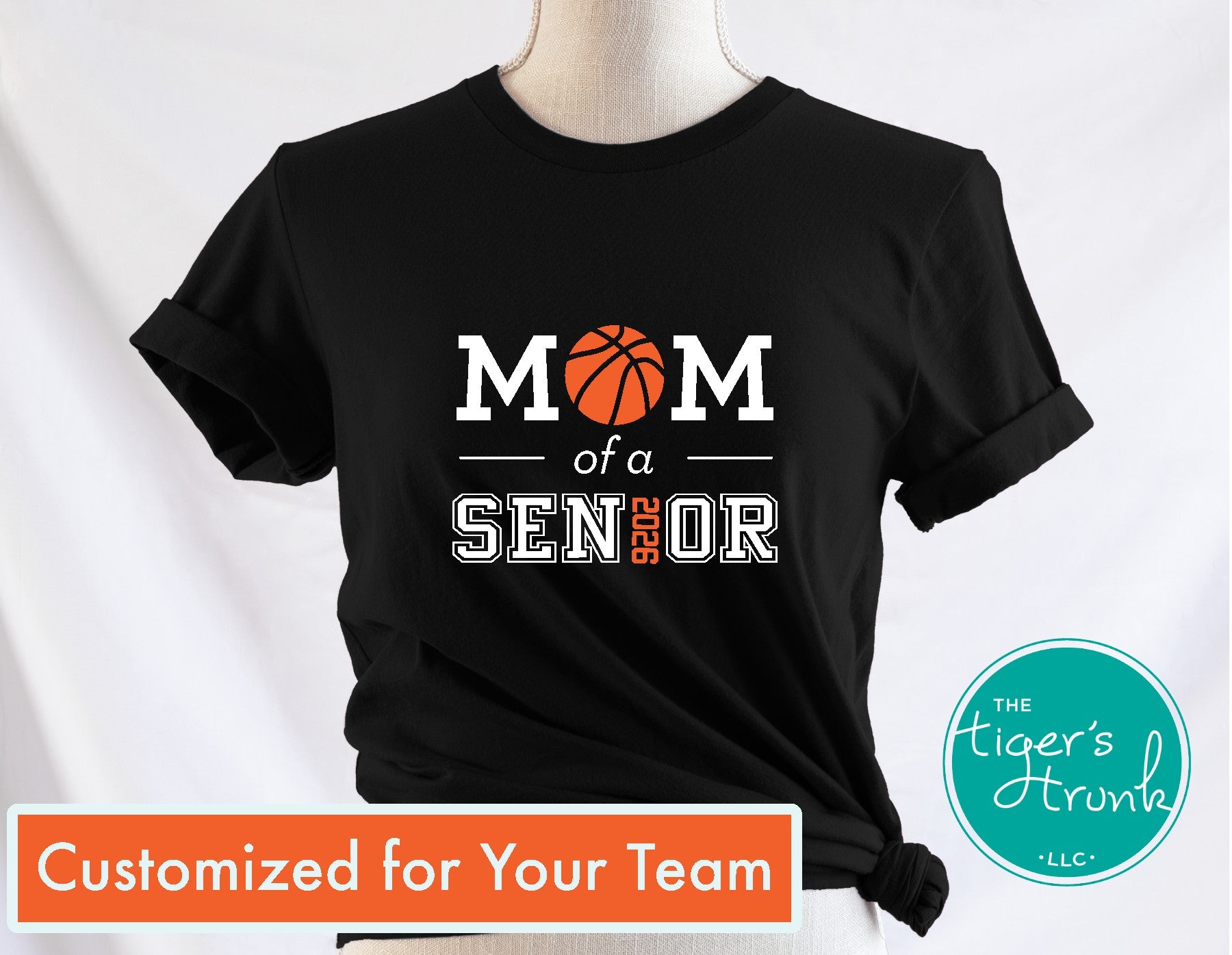 Black t-shirt with 'Mom of a Senior' design on a mannequin against a white background, featuring the brand 'The Tiger's Trunk'.