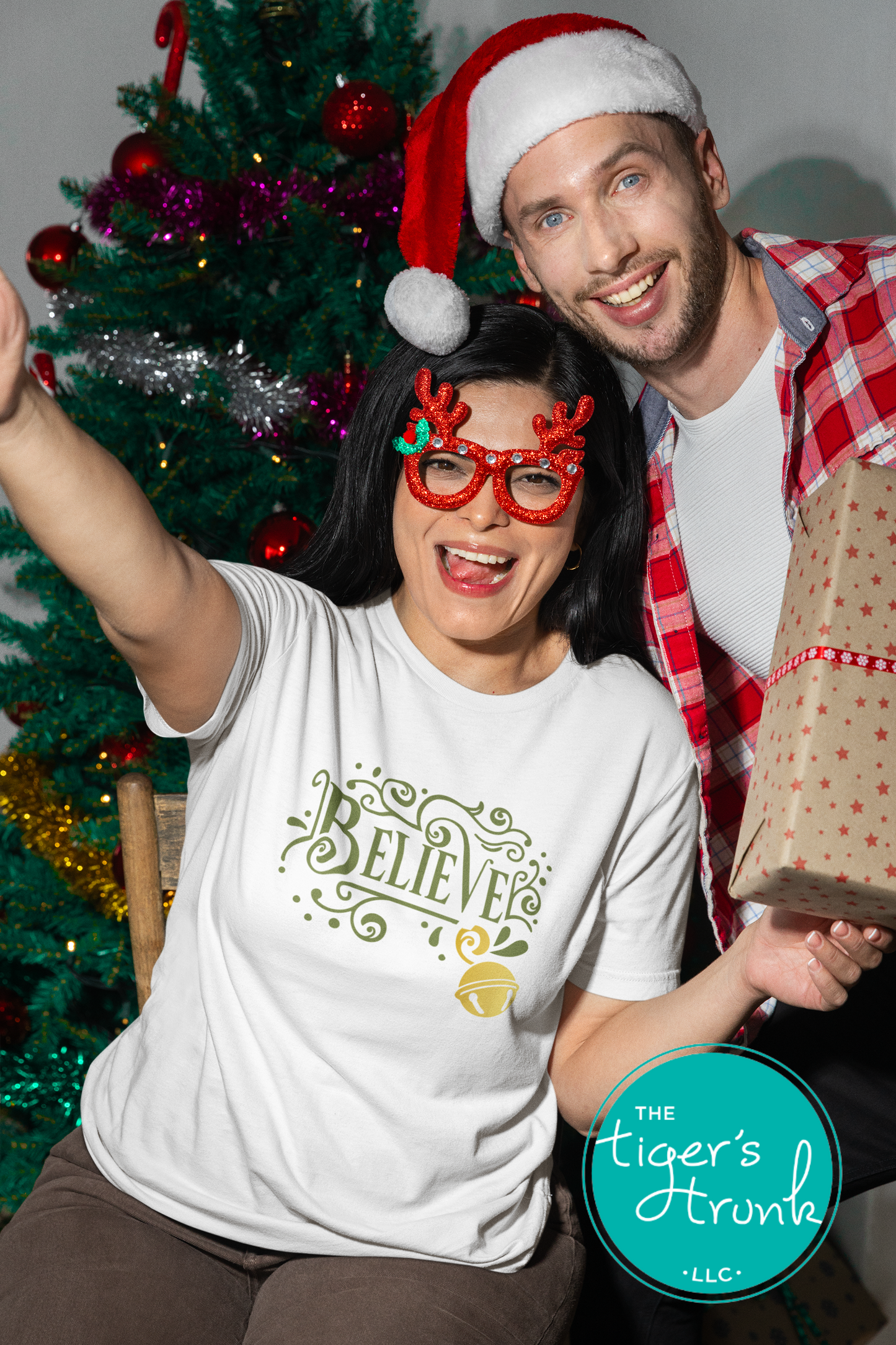 Two people celebrating Christmas with a decorated tree in the background.