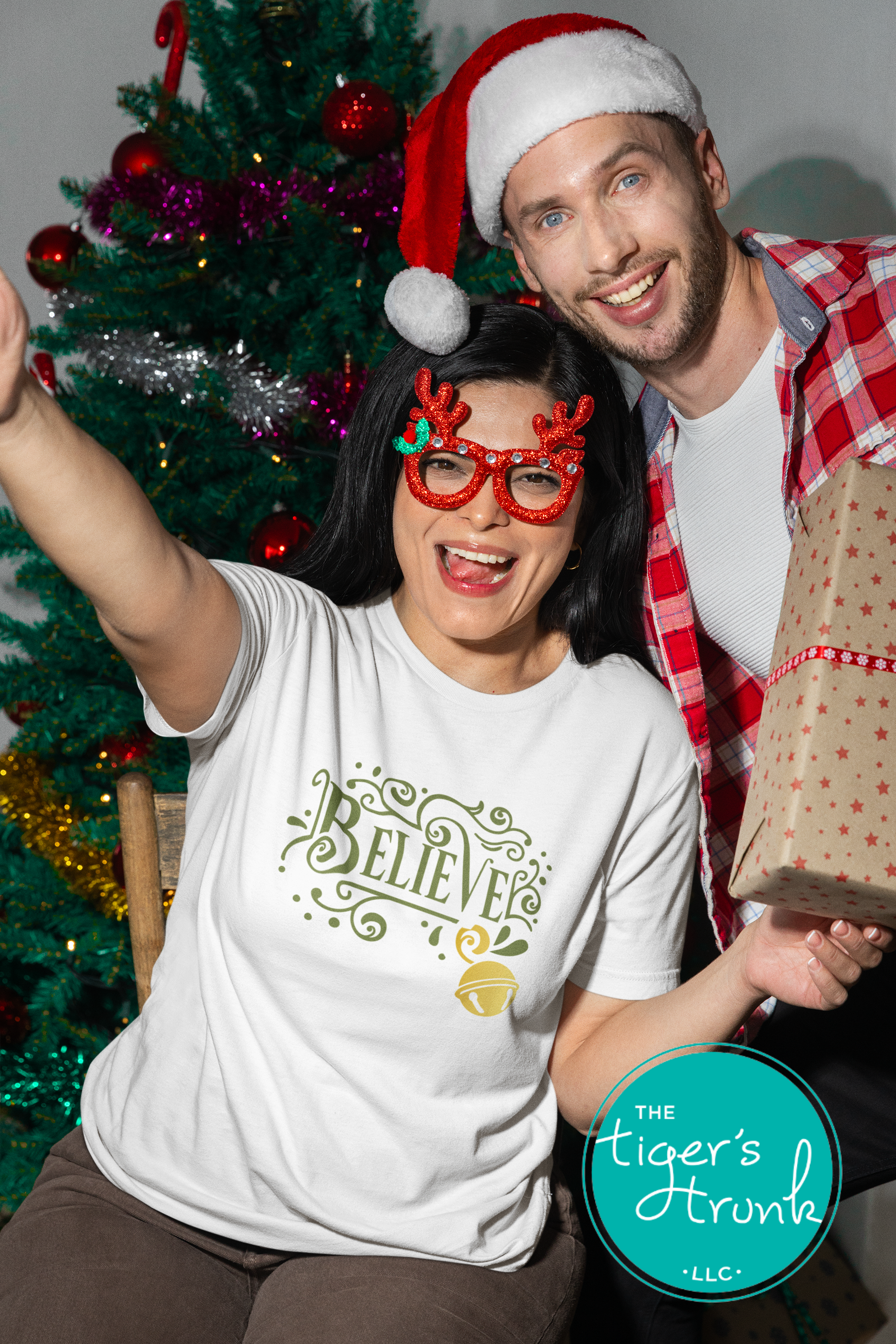 Two people celebrating Christmas with a decorated tree in the background.