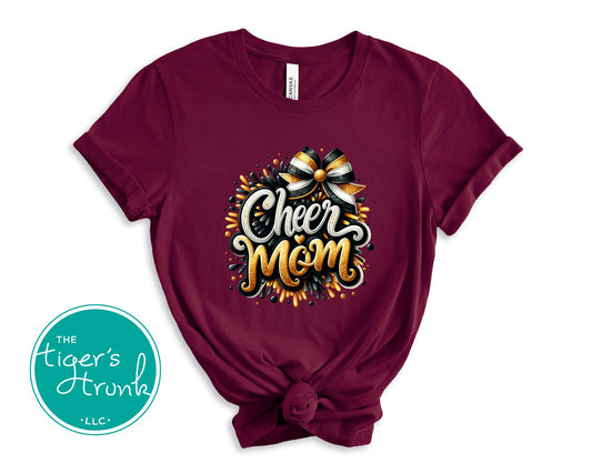 Maroon t-shirt with 'Cheer Mom' design and bow graphic on a white background, featuring The Tiger's Den logo.