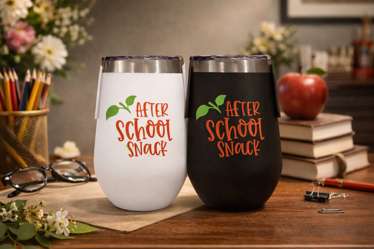 Two tumblers with 'After School Snack' text on a desk with books and flowers.