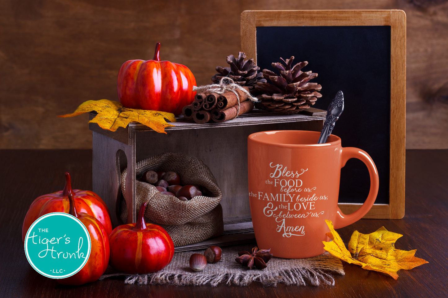 Autumn-themed setting with pumpkins, pinecones, and a mug on a wooden surface.
