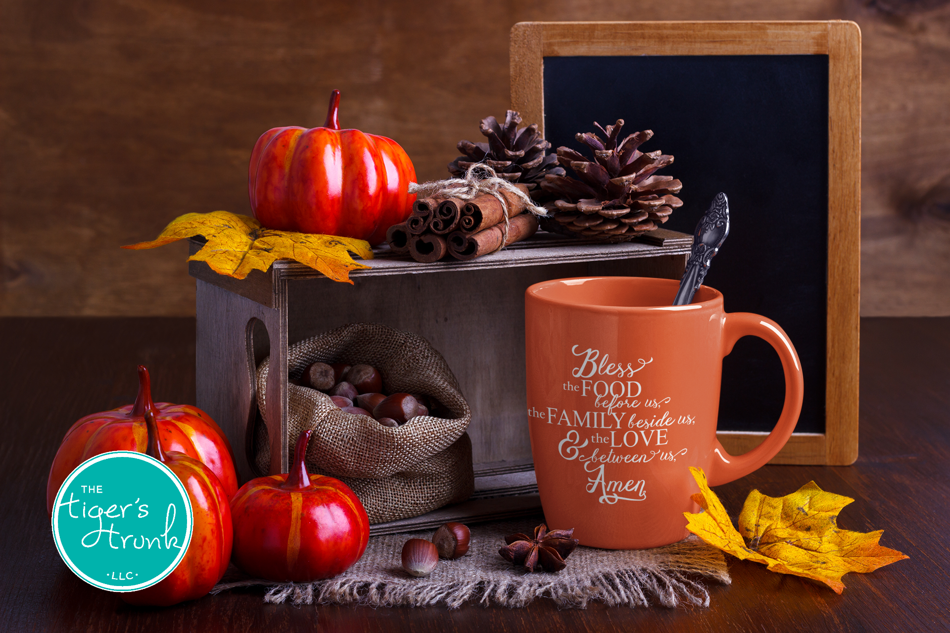 Autumn-themed setting with pumpkins, pinecones, and a mug on a wooden surface.