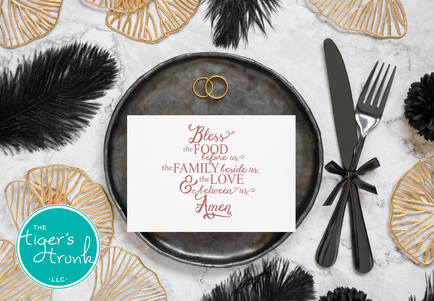 Dinner setting with a decorative card, cutlery, and festive elements on a textured surface.
