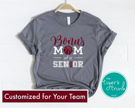 Gray t-shirt with 'Bonus Mom of a Senior' text on a hanger, branded with 'The Tiger's Trunk'.