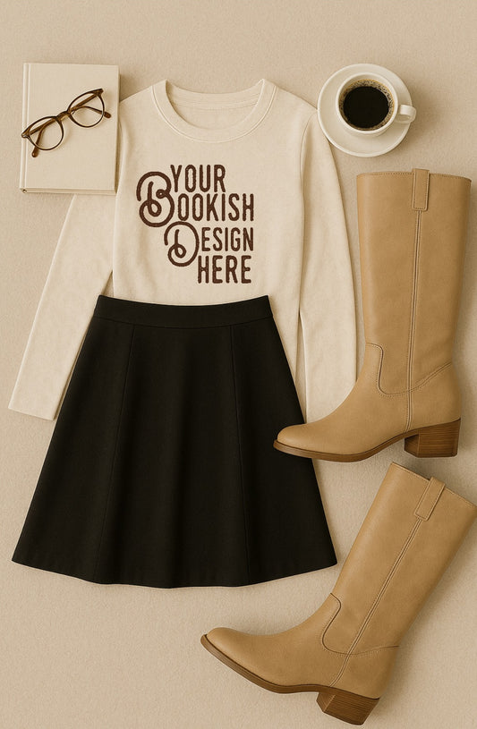White shirt with 'Your Bookish Design Here' text, black skirt, tan boots, glasses, and coffee cup on a beige surface.