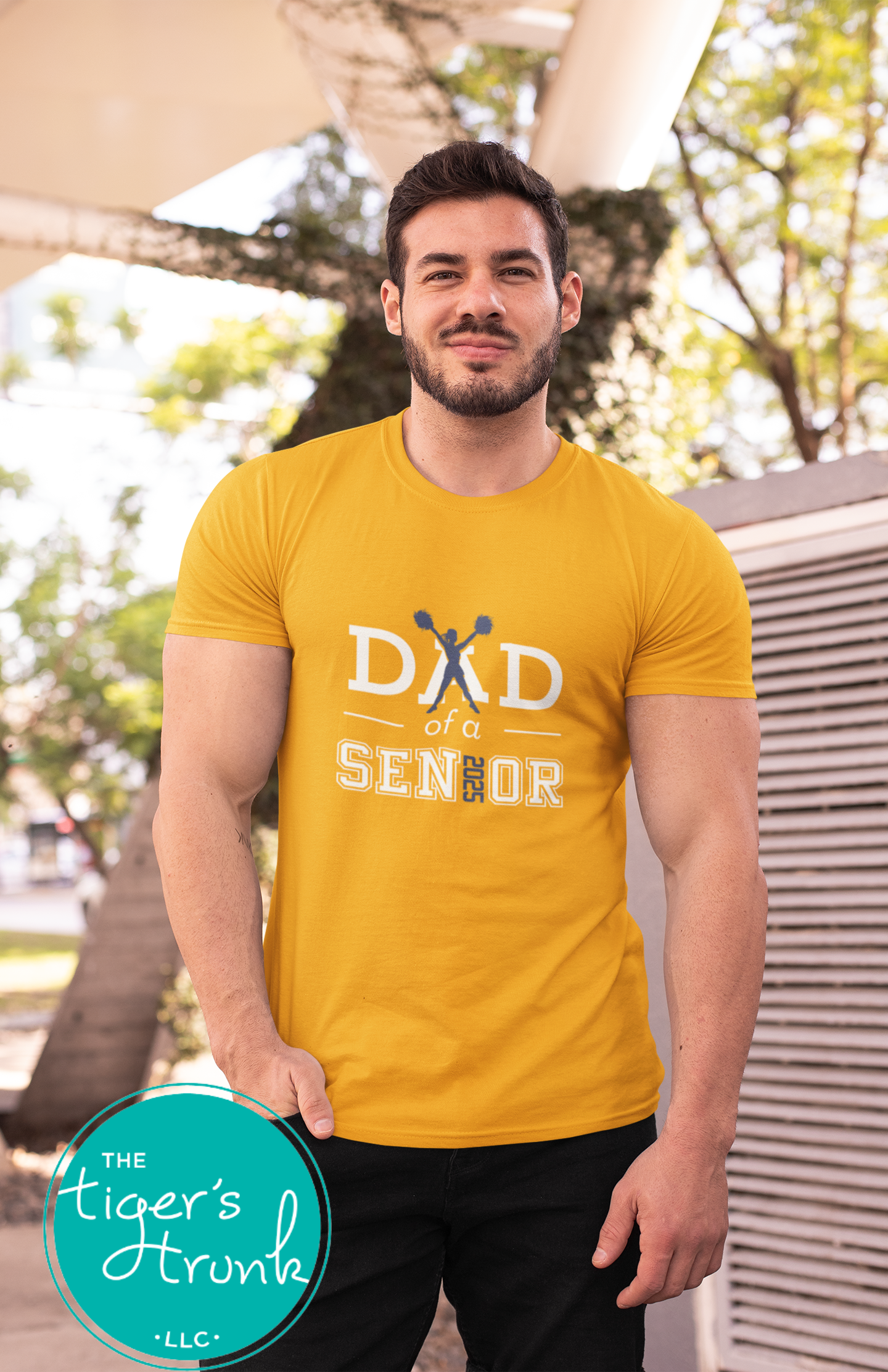 Man wearing a gold Cheer Dad of a Senior shirt customized for school colors.