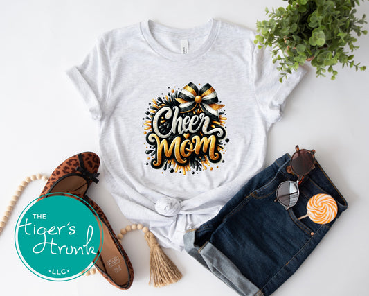 Ash t-shirt with 'Cheer Mom' design, sunglasses, denim shorts, and shoes on a white background.