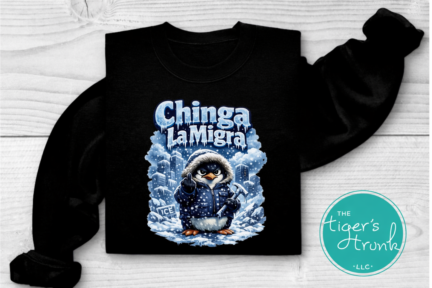 Black sweatshirt with a penguin graphic and 'Chinga La Migra' text on a white background