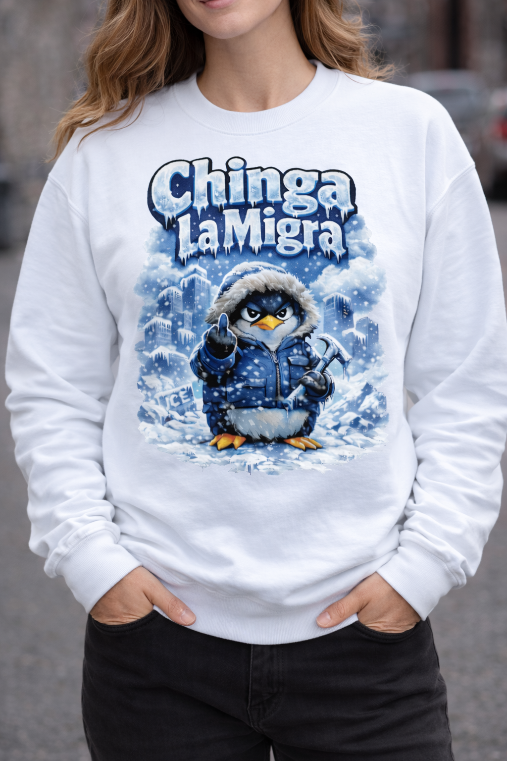 Person wearing a white sweatshirt with a penguin graphic and 'Chinga La Migra' text.