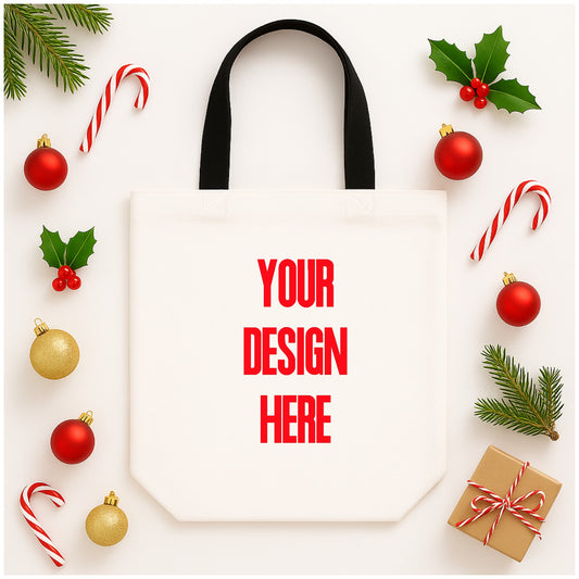White tote bag with 'Your Design Here' text, surrounded by Christmas decorations on a white background