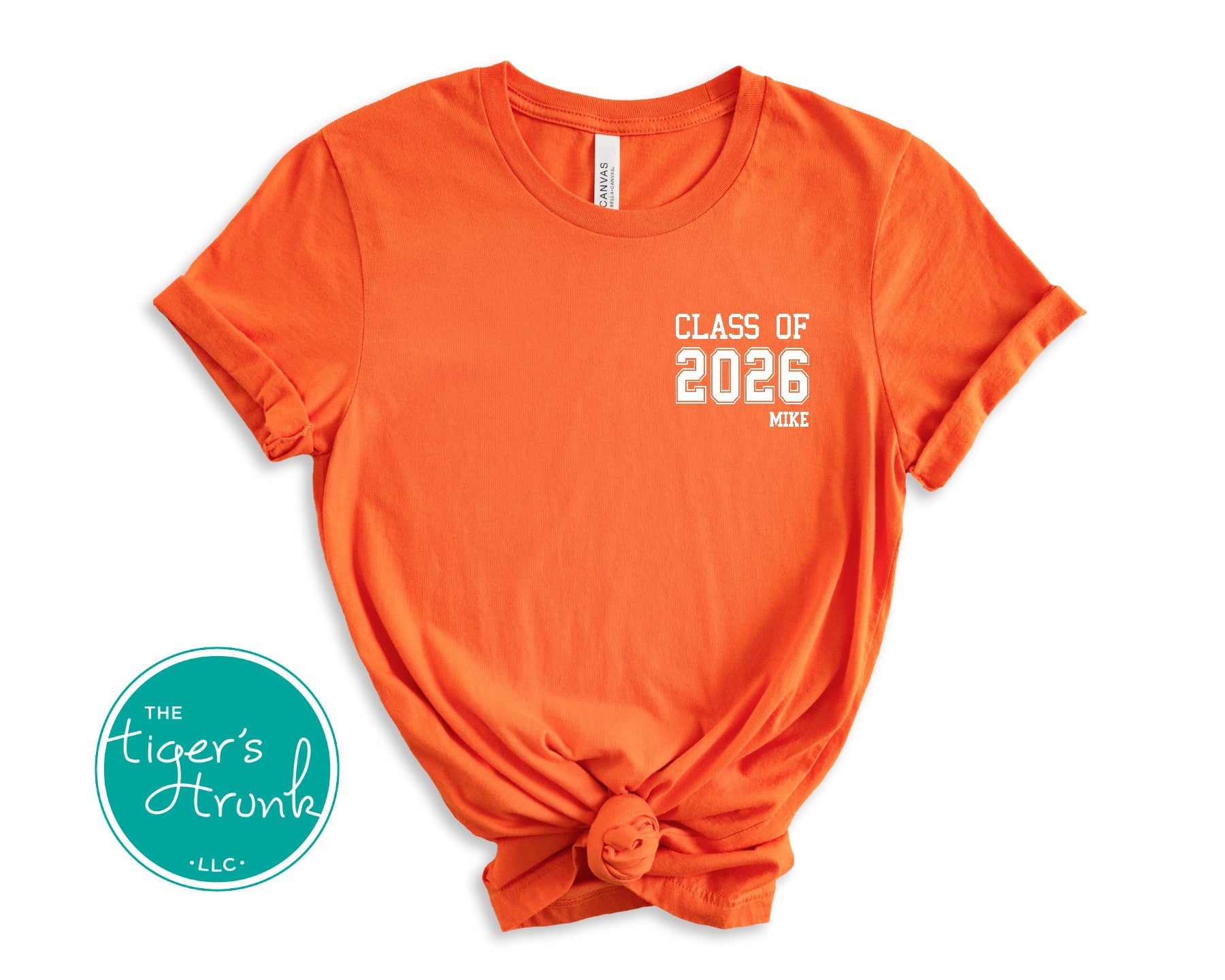 Orange t-shirt with 'Class of 2026' text on a white background, featuring The Tiger's Trunk logo.