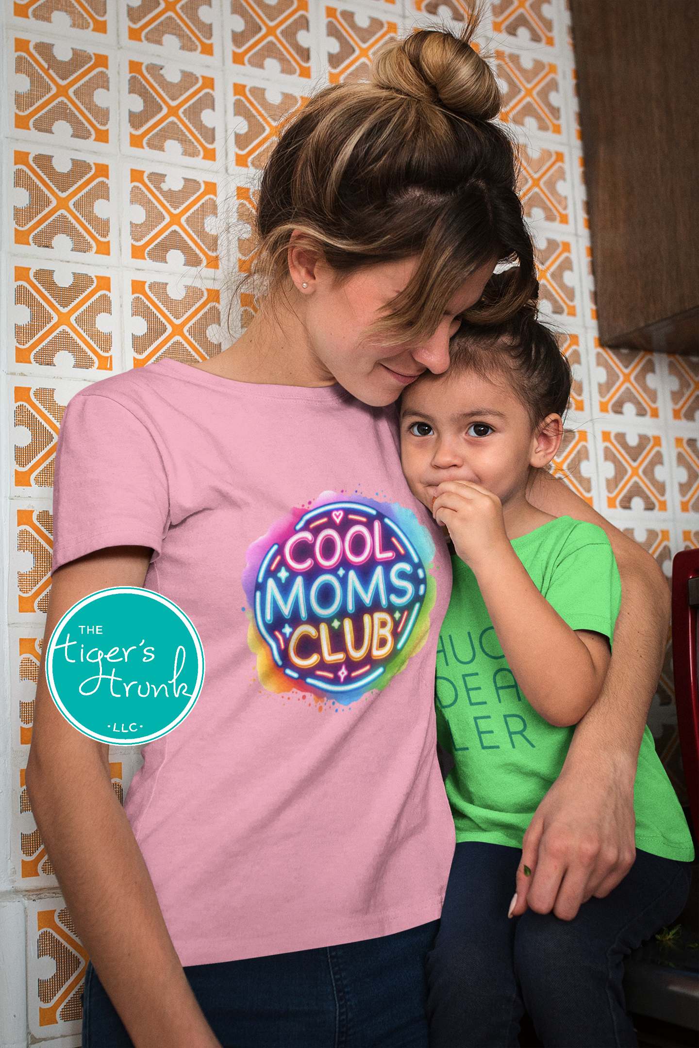 Graphic t-shirt with Cool Mom's Club text in neon colors, fun and trendy design for stylish moms