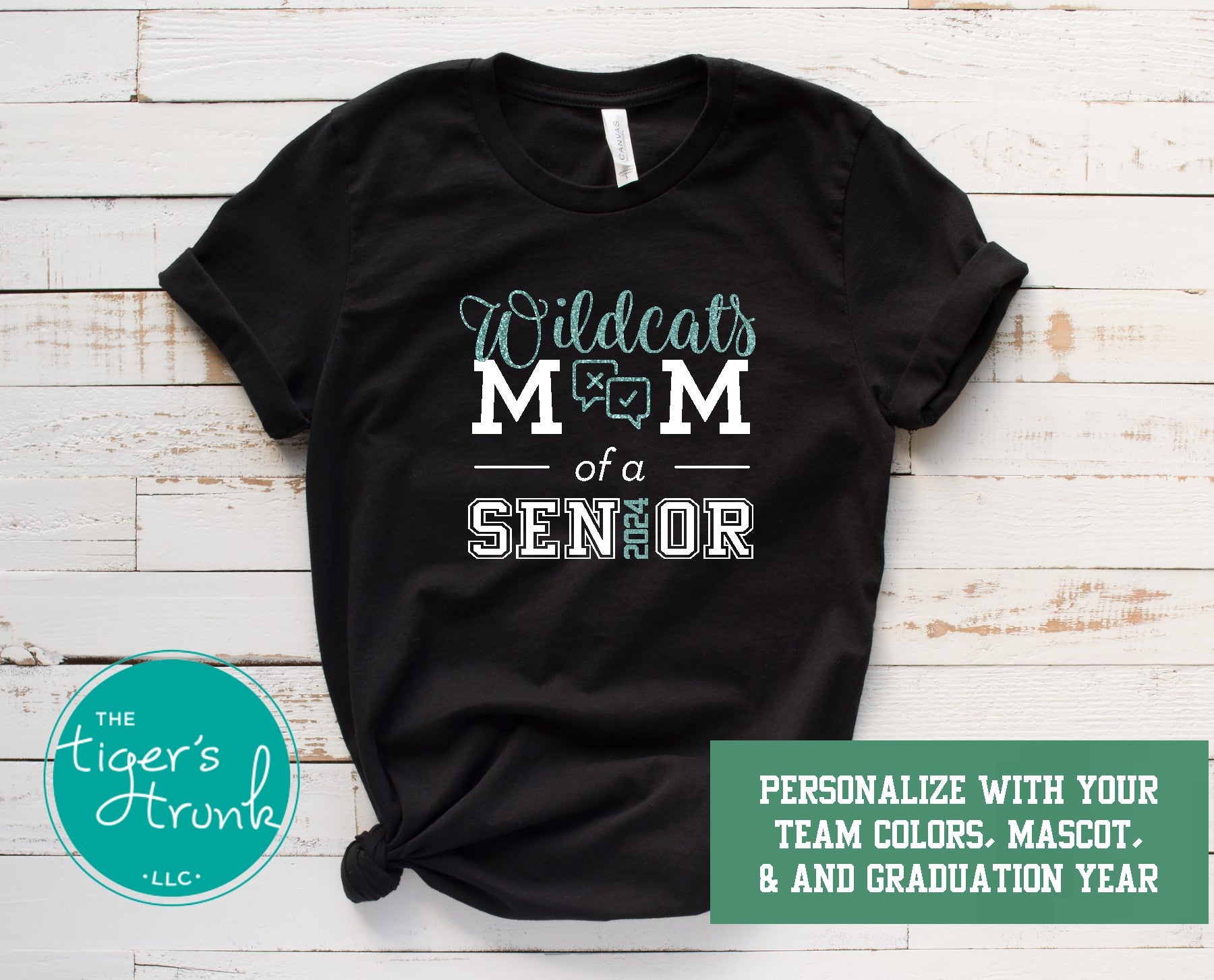 A black short-sleeve shirt with white text and graphics, featuring the phrase 'Wildcats Mom of a Senior' and the graduation year '2025'. The shirt is customizable with a mascot and graduation colors, and it has a logo at the bottom.