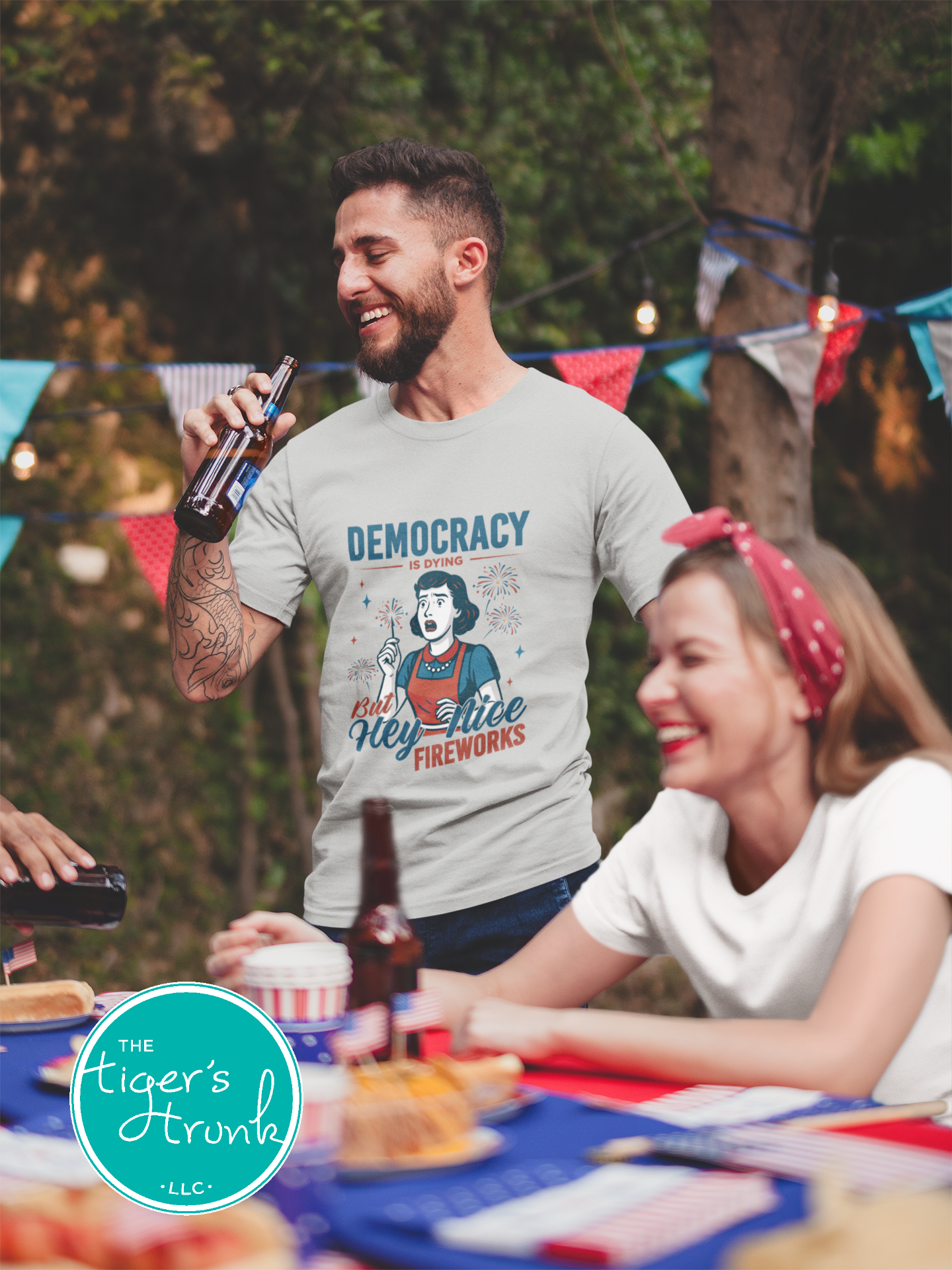 Funny political t-shirt that reads Democracy Is Dying But Hey, Nice Fireworks, worn for sarcastic July Fourth cookouts