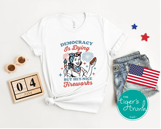 Patriotic graphic t-shirt that reads Democracy Is Dying But Hey, Nice Fireworks, political and sarcastic July Fourth shirt