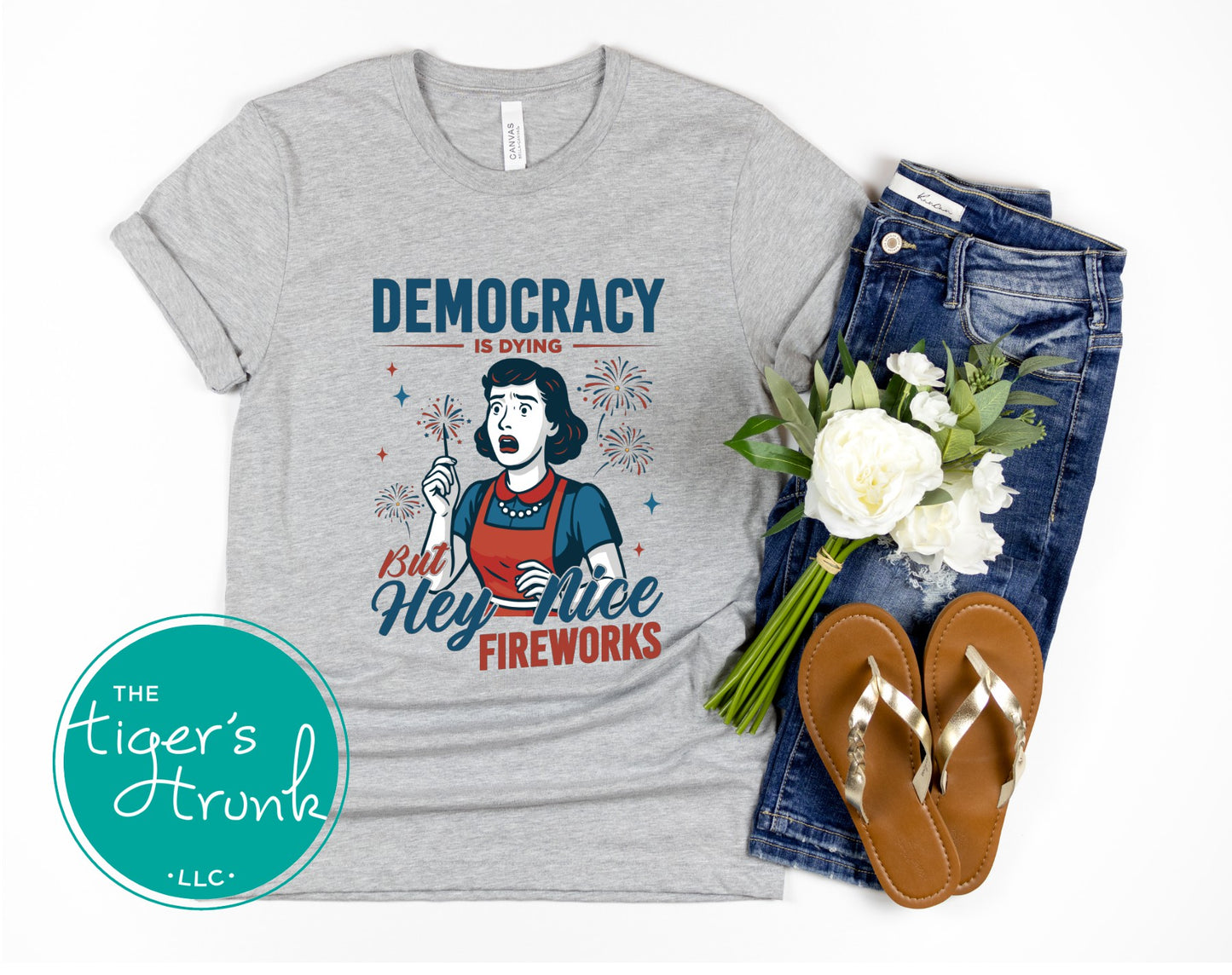 Funny political t-shirt that reads Democracy Is Dying But Hey, Nice Fireworks, worn for sarcastic July Fourth cookouts