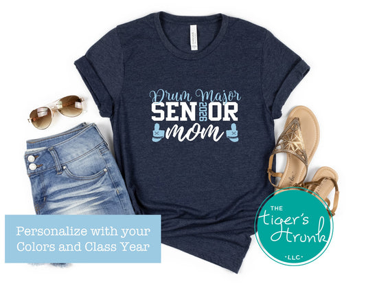 Navy t-shirt with 'Drum Major Senior Mom' text, sunglasses, jeans, and sandals on a white background.