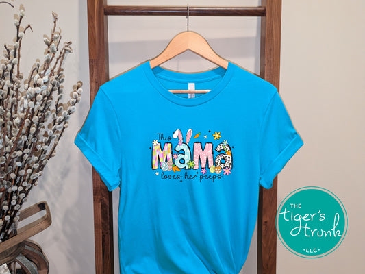 Easter t-shirt with "Mama" in colorful pastel spring print font, featuring floral and bunny-themed design perfect for holiday celebrations