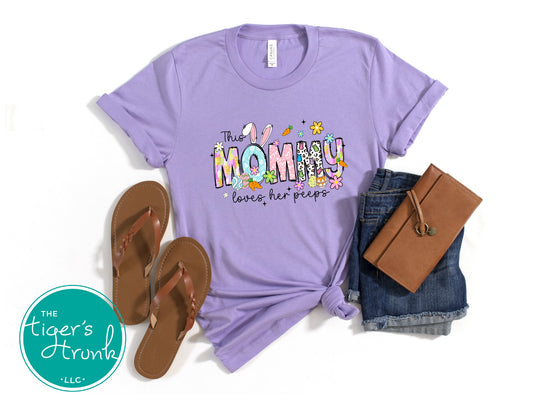 Easter t-shirt with "Mommy" in spring print font featuring bunnies, eggs, and flowers, perfect for holiday wear and family gatherings