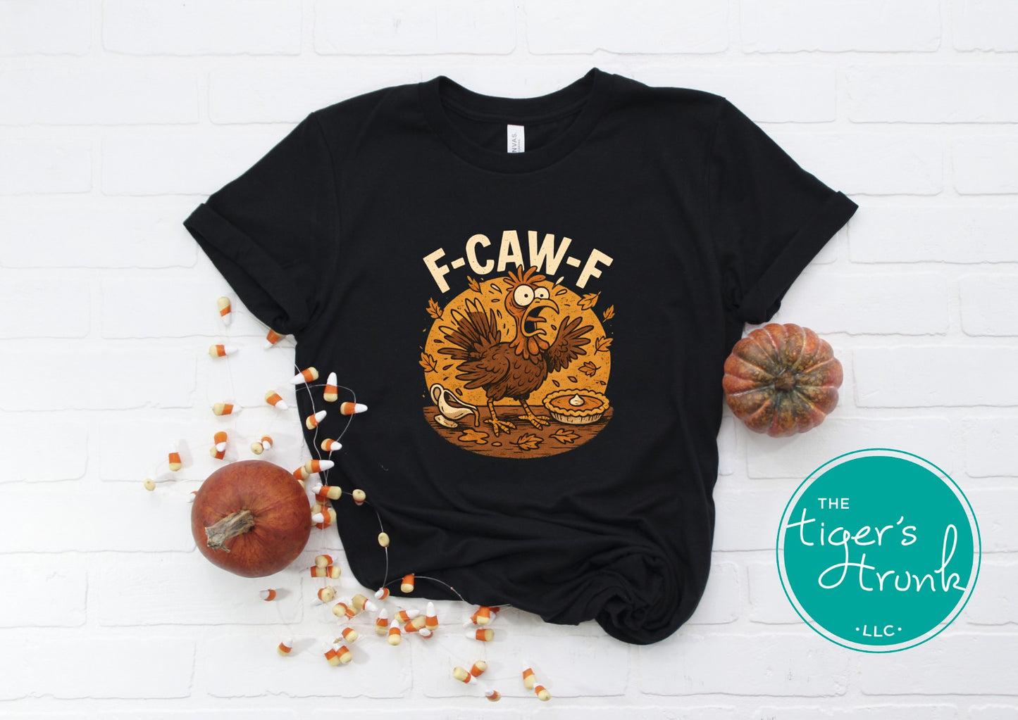 Black t-shirt with a turkey graphic and 'F-CAW-F' text on a white background with pumpkins and corn.