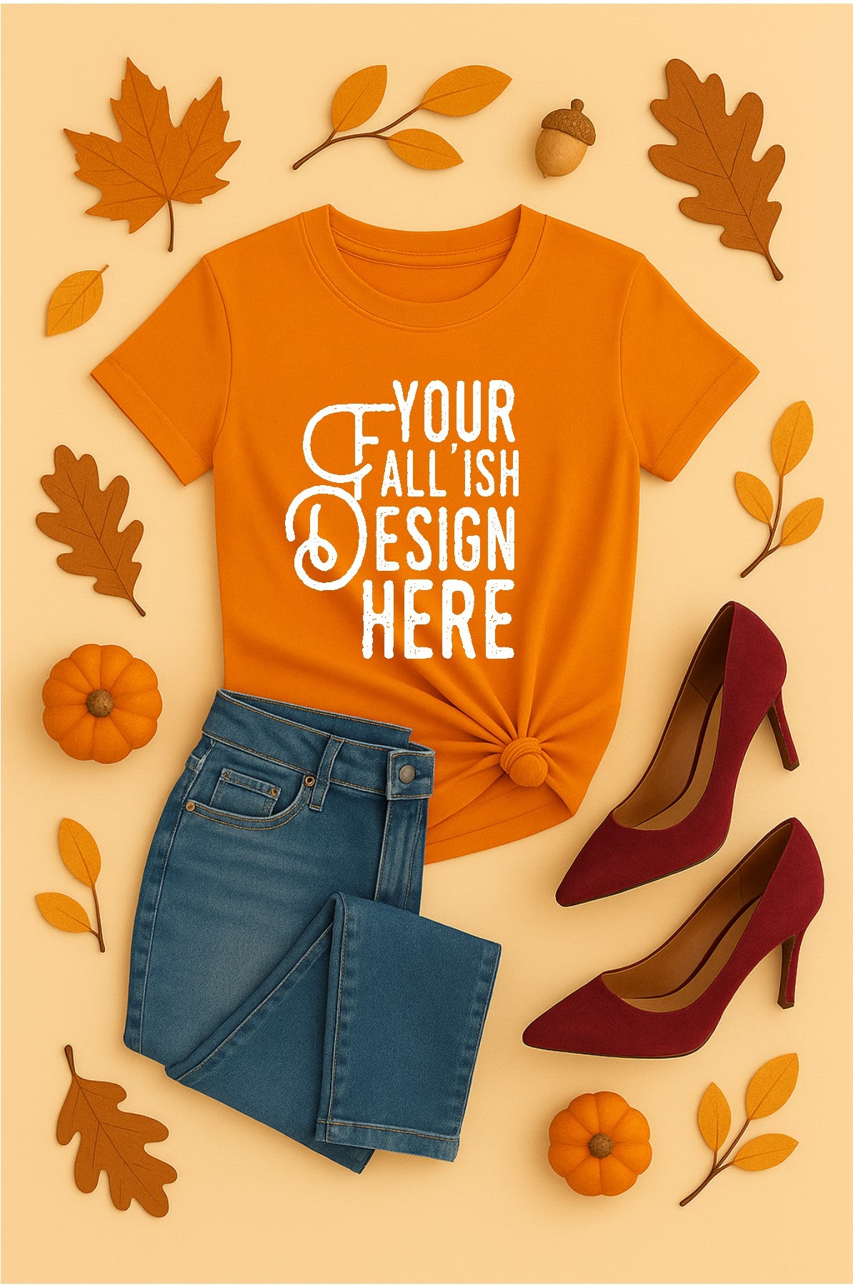 Orange t-shirt with 'Your Fall Ish Design Here' text, blue jeans, red high heels, and autumn leaves on a beige background.