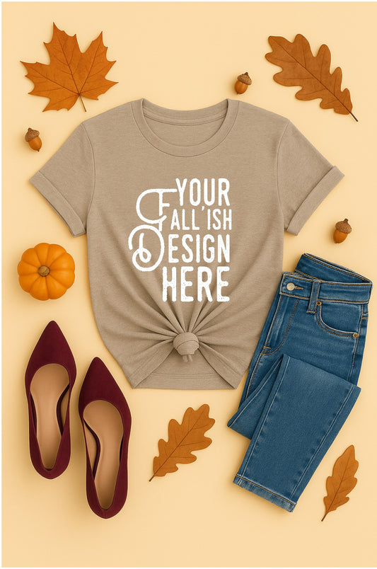 Beige t-shirt with 'Your Fall-ish Design Here' text, blue jeans, maroon shoes, and autumn leaves on a beige background